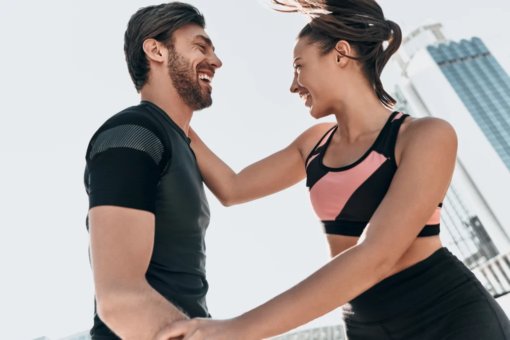 laughing couple exercising outdoors in the city utc